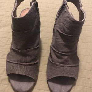 Grey woven type canvas shoe with heel.